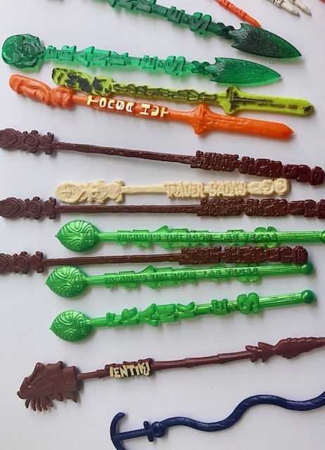 orange, white, green and brown tiki swizzle sticks