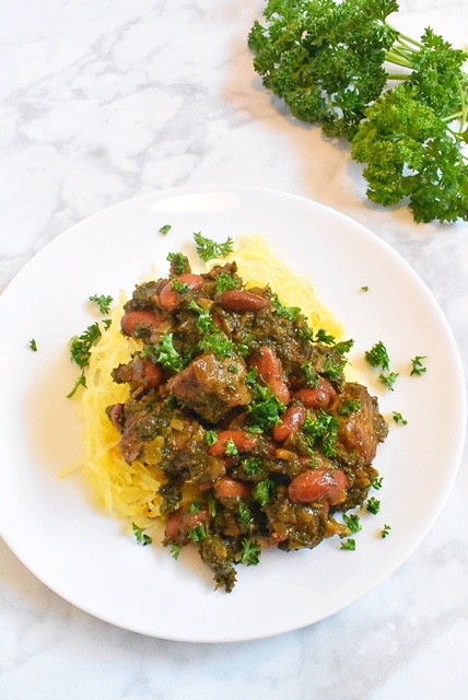 persian lamb stew ghormeh sabzi with chopped parsley and baked spaghetti squash