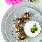 greek lamb meatballs on white platter by Emily Kyle