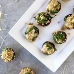 sorghum stuffed mushrooms on white rectangle platter and gray background