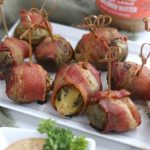 bacon wrapped brussel sprouts with sunbutter dipping sauce on white platter