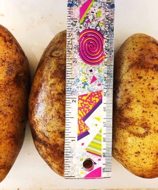 3 raw russet potatoes and ruler