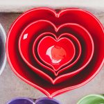 four stacked red heart ramekins