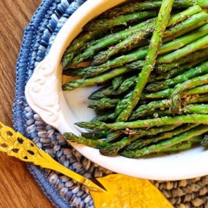 roasted green asparagus on white platter
