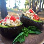 grilled avocado halves stuffed with tuna salad in wilderness setting