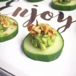 cucumber slices with guacamole and walnut appetizer