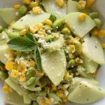 white bowl with close up of chayote squash, corn and edamame succotash