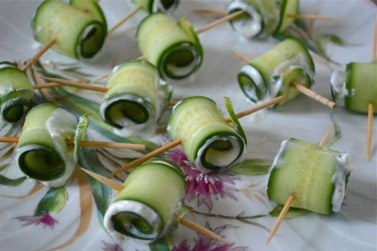 cucumber roll ups with feta and mint skewered on a toothpick