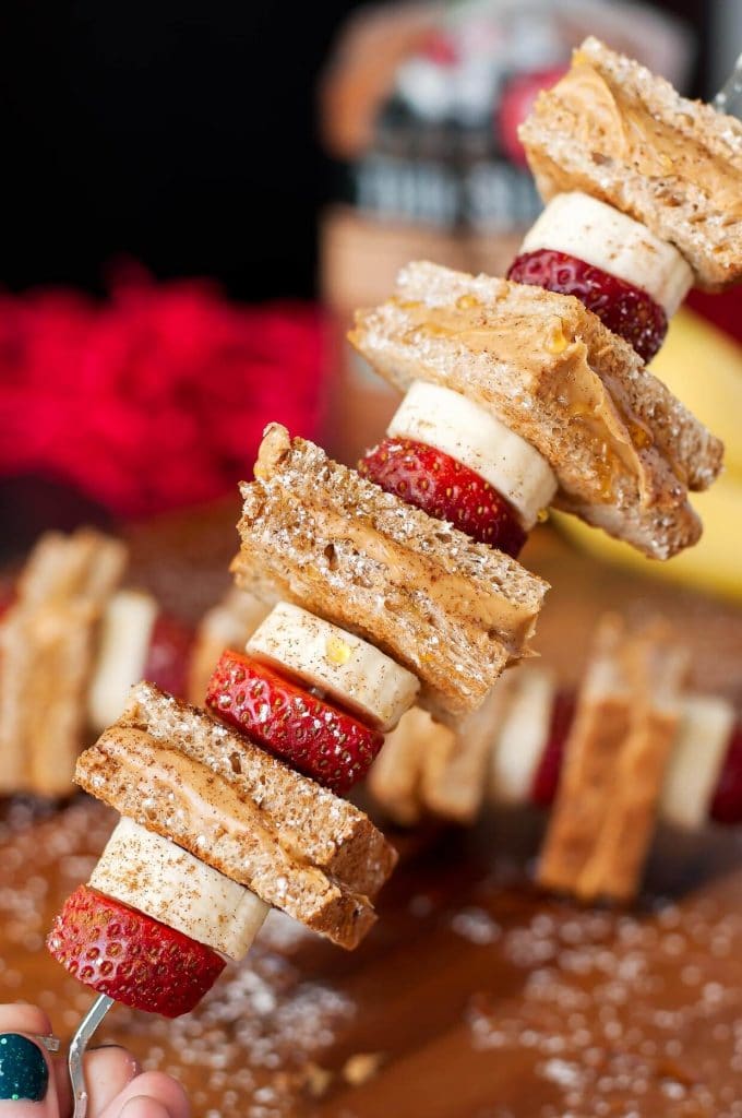 peanut butter toast, banana and strawberries on a stick