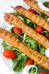 seekh chicken kababs with spinach, onions and tomato