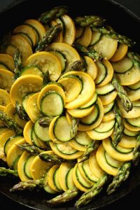 sliced yellow squash and zucchini in gratin dish