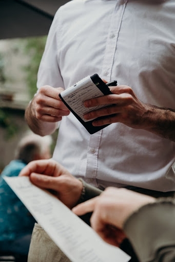 server wearing a white shirt taking a customer's order at a restaurant